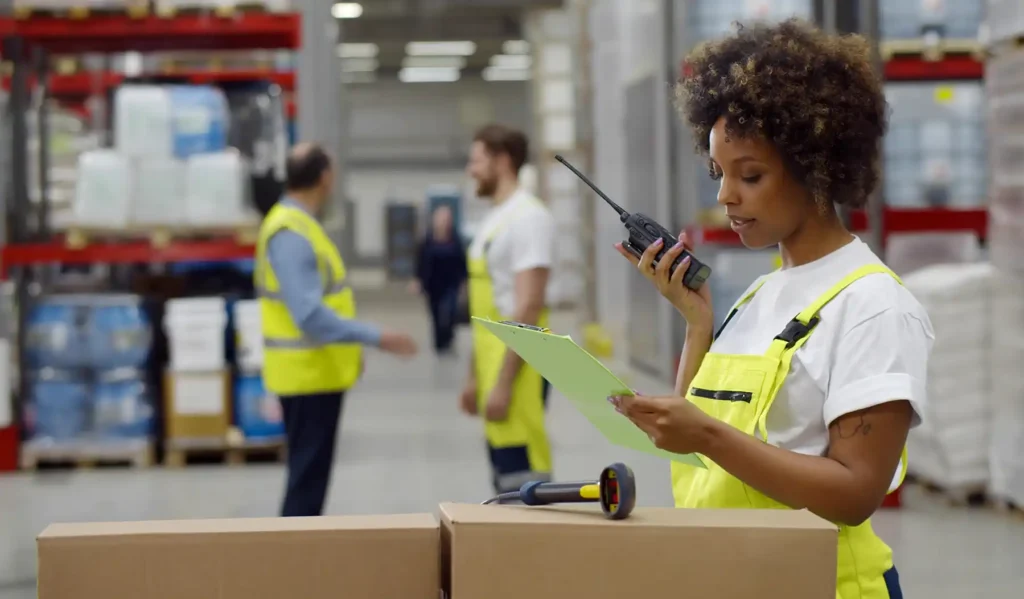 African female warehouse manager holding