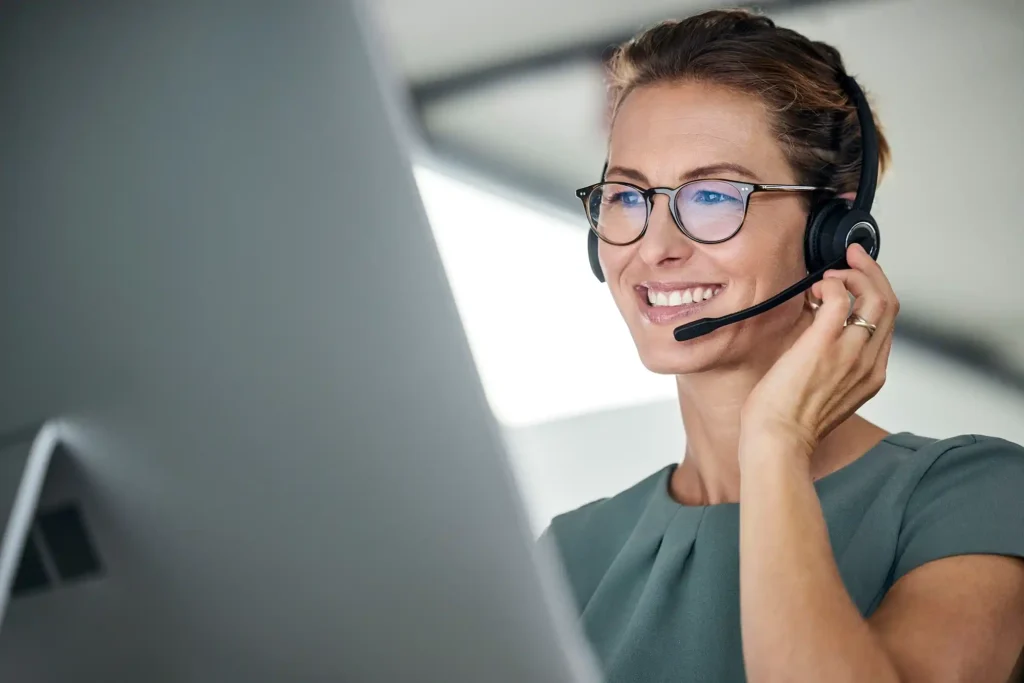 Customer service, woman and happy call center agent giving advice online using a headset