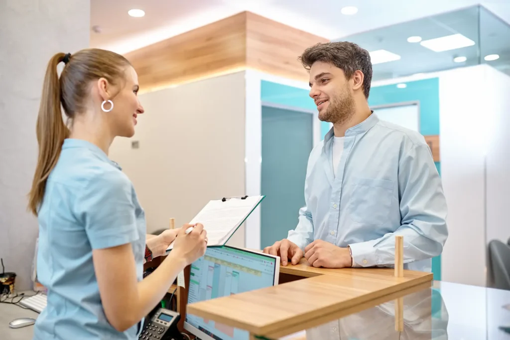 Man talking to professional receptionist